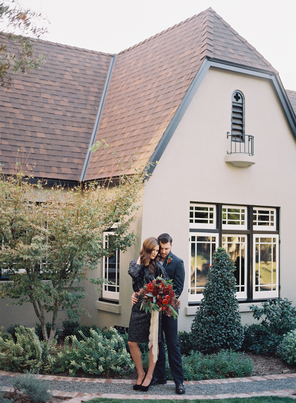 bride and groom in front of historic home in Orange County