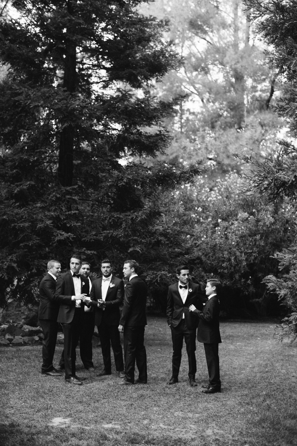 black and white photo of groomsmen waiting for wedding ceremony to start at calamigos ranch in southern california