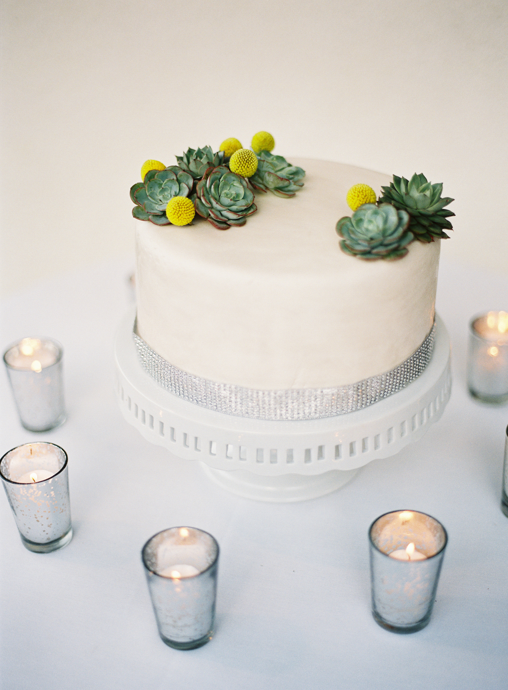 a wedding cake with succulents