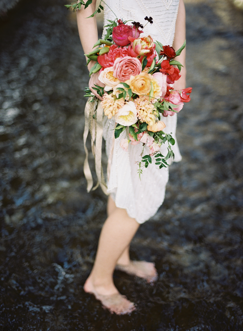 a film photograph of a bride holding her wedding bouquet by ashley beyer of tinge
