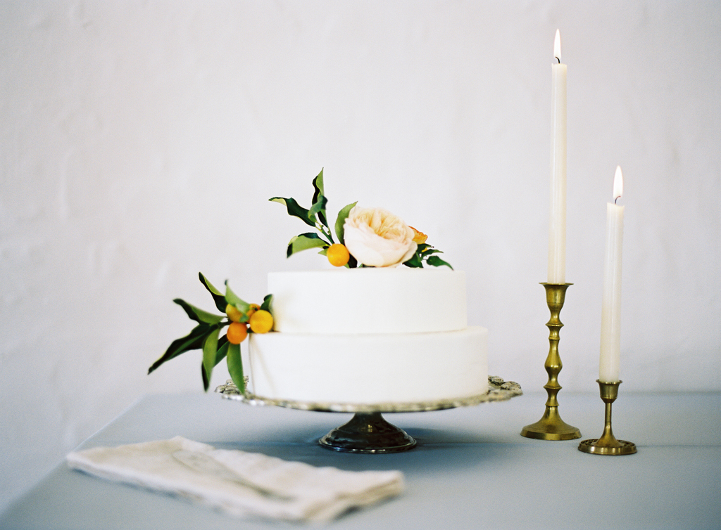 a white, clean wedding cake by pippa cakery decorated with flowers by Tinge