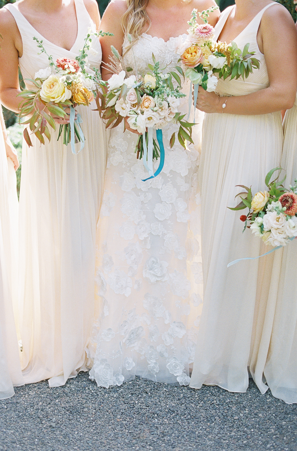 detail of bridesmaids dresses and bouquets at a napa wedding at the venue beaulieu gardens
