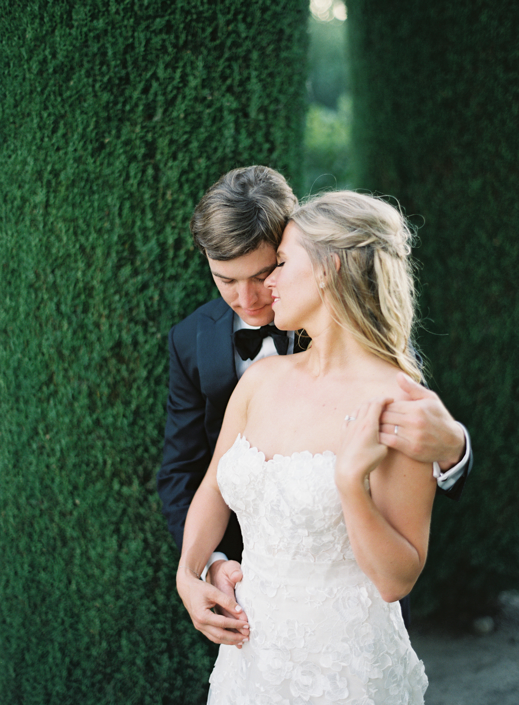 portrait of a bride and groom on their wedding day at beaulieu gardens in napa shot by a film photographer 