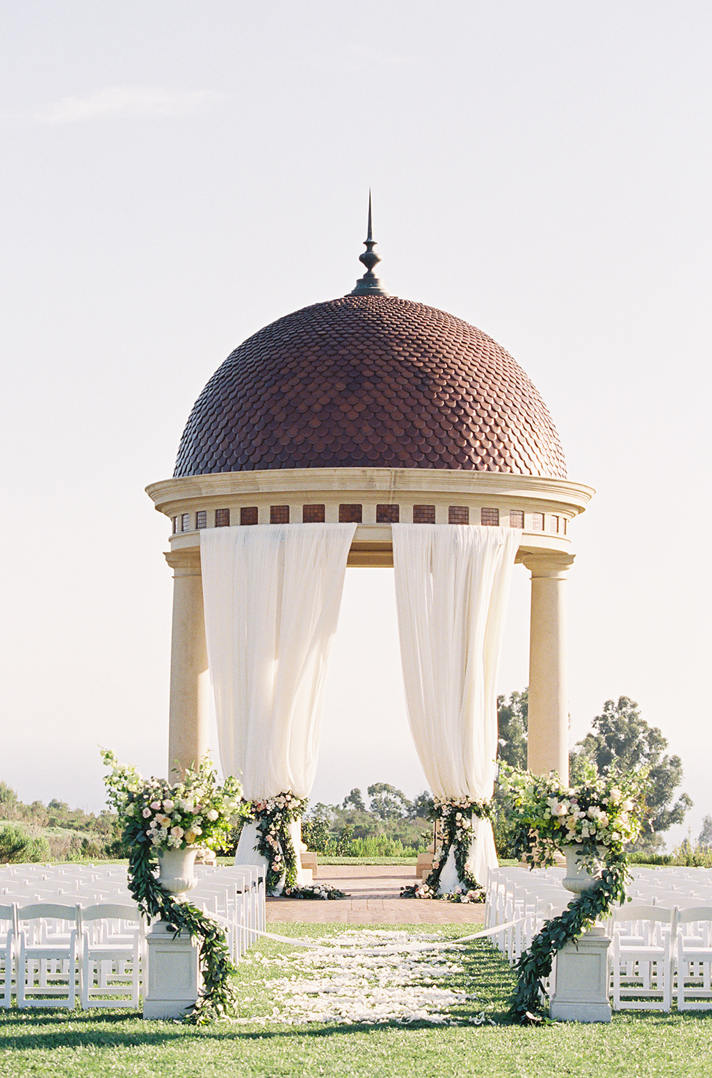 a colorful garden themed wedding ceremony at pelican hill resort in california