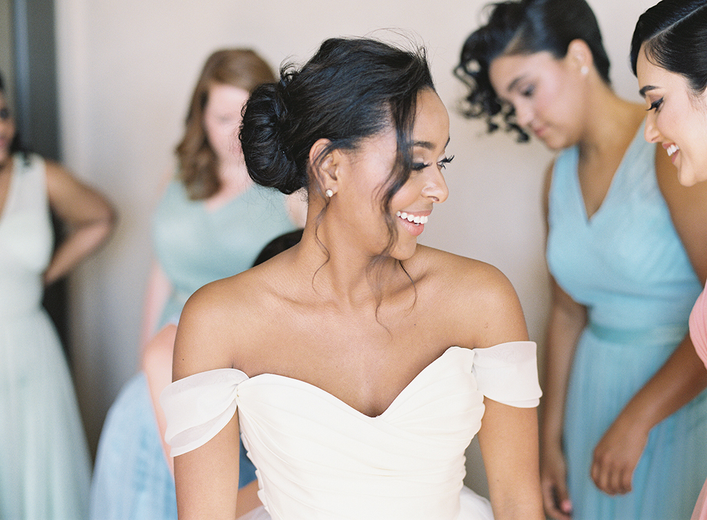 a bride and her bridesmaids getting ready in their suite at pelican hill