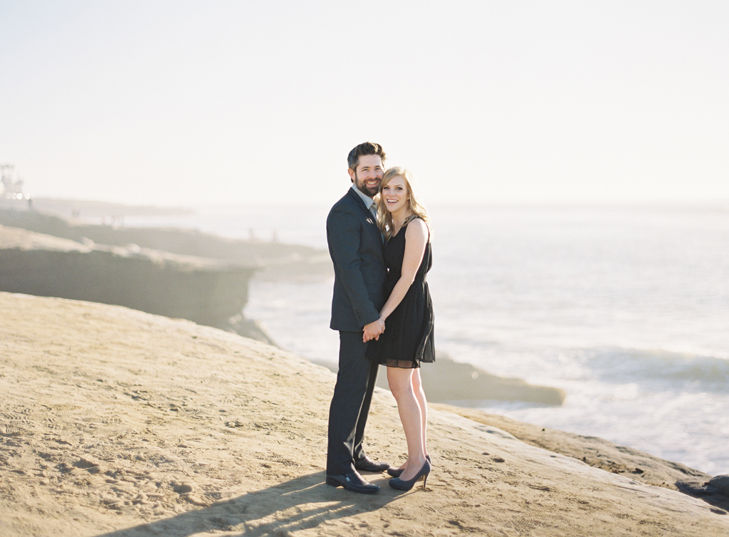 standing along a cliff in southern california, this couple poses for their engagement session captured on film photography.