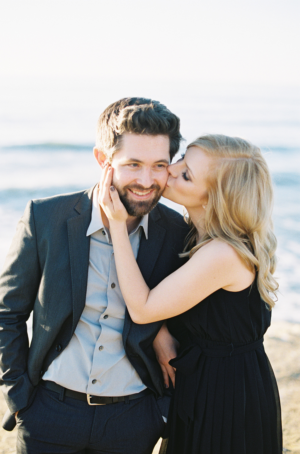 a soon-to-be bride kissed her fiance during their coastal engagement session in San Diego.