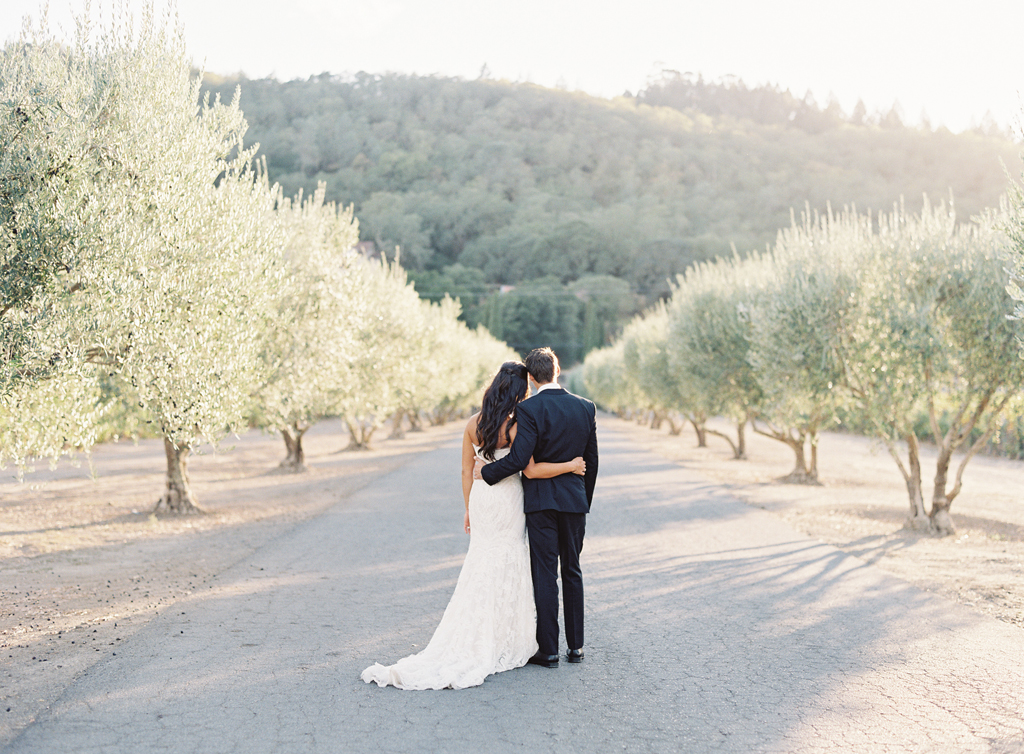 A bride and groom posing at a Napa Winery on their wedding day with a film photographer.