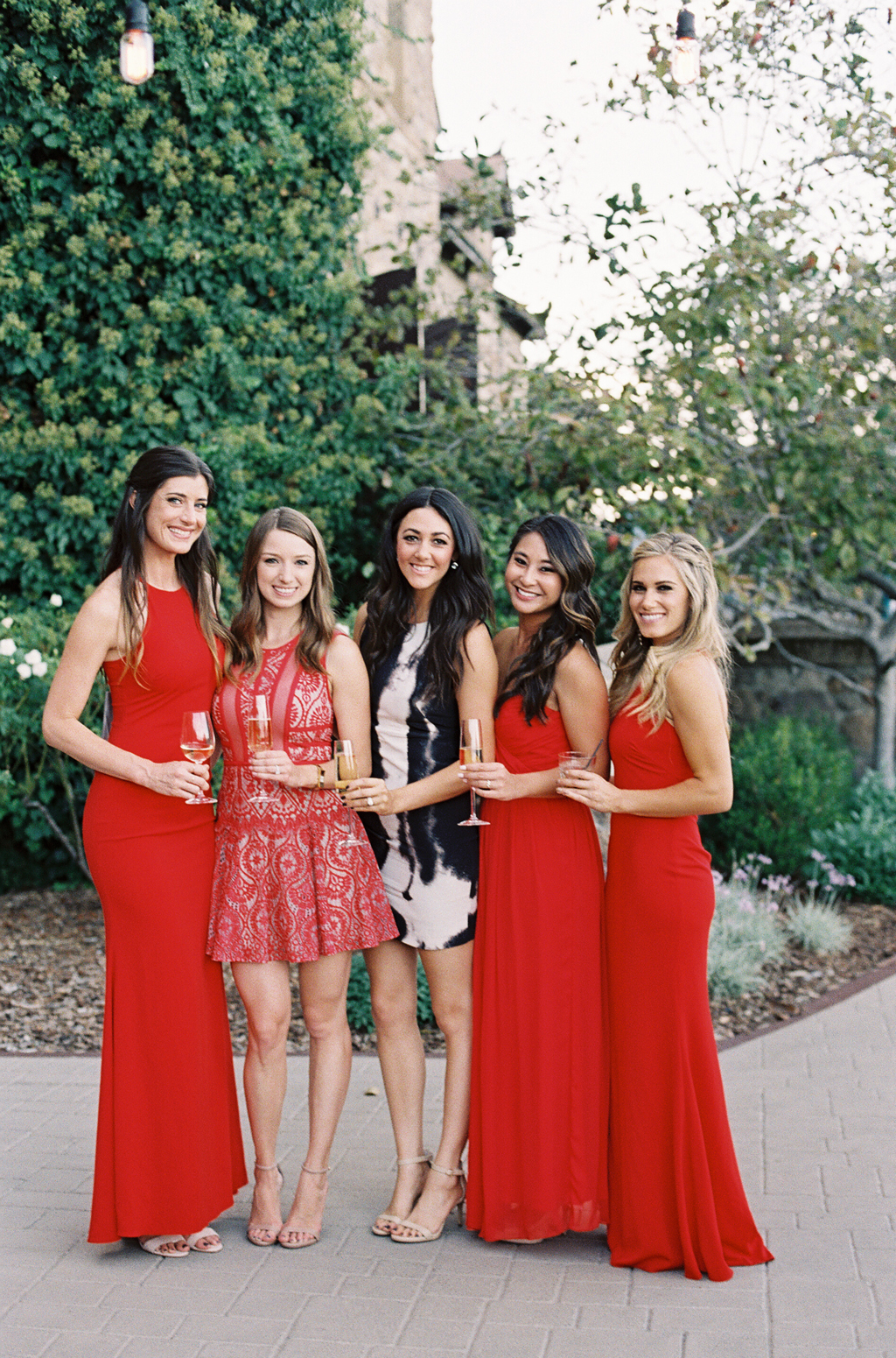 Bridesmaids wearing red dresses during the cocktail hour at a Napa Valley Wedding. 