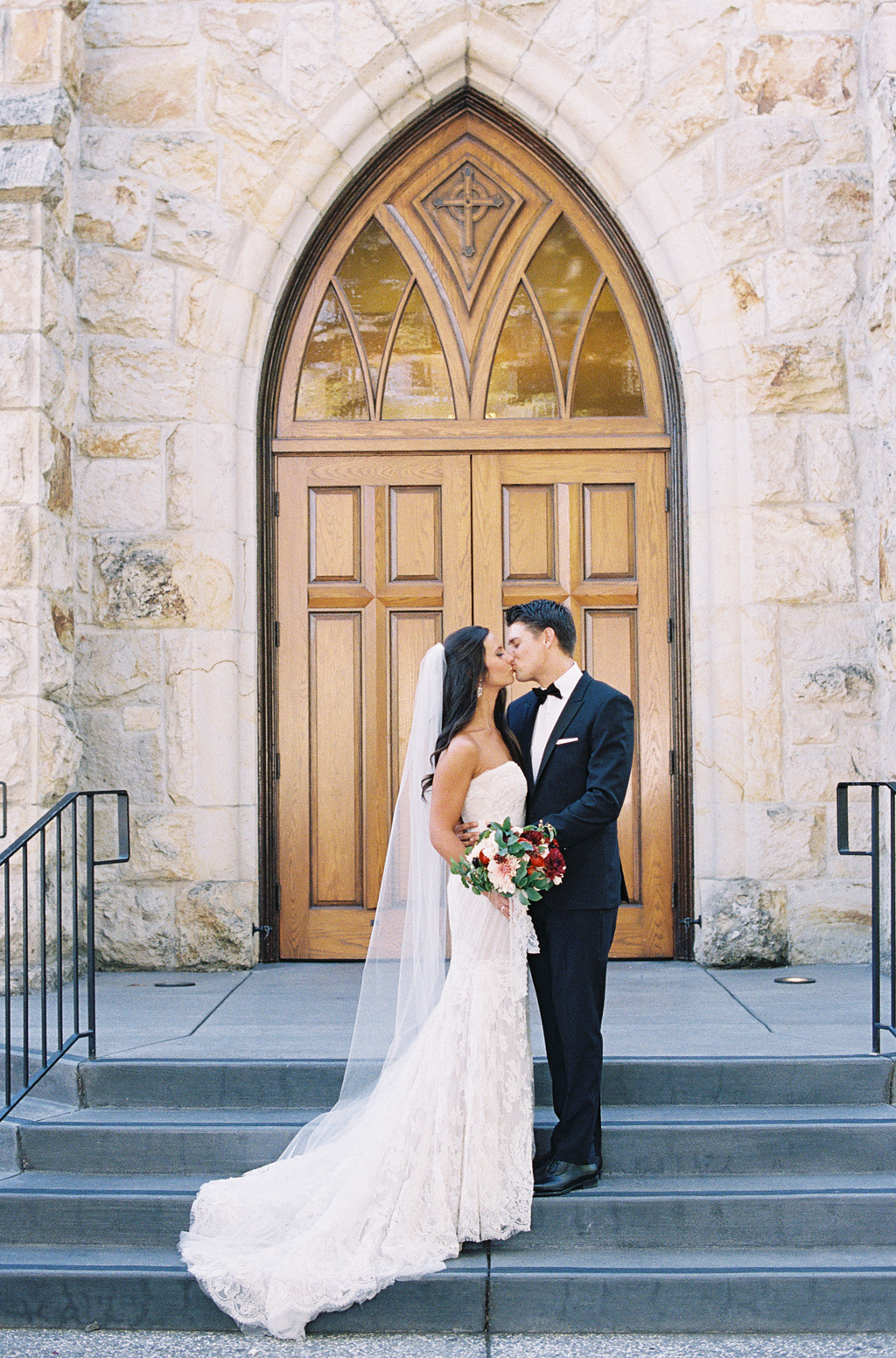 a bride and groom pose in front of a church in St. Helena, California. 